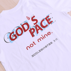 White t-shirt with text that says 'GOD'S PACE not mine.' and 'Ecclesiastes 3:11' below
