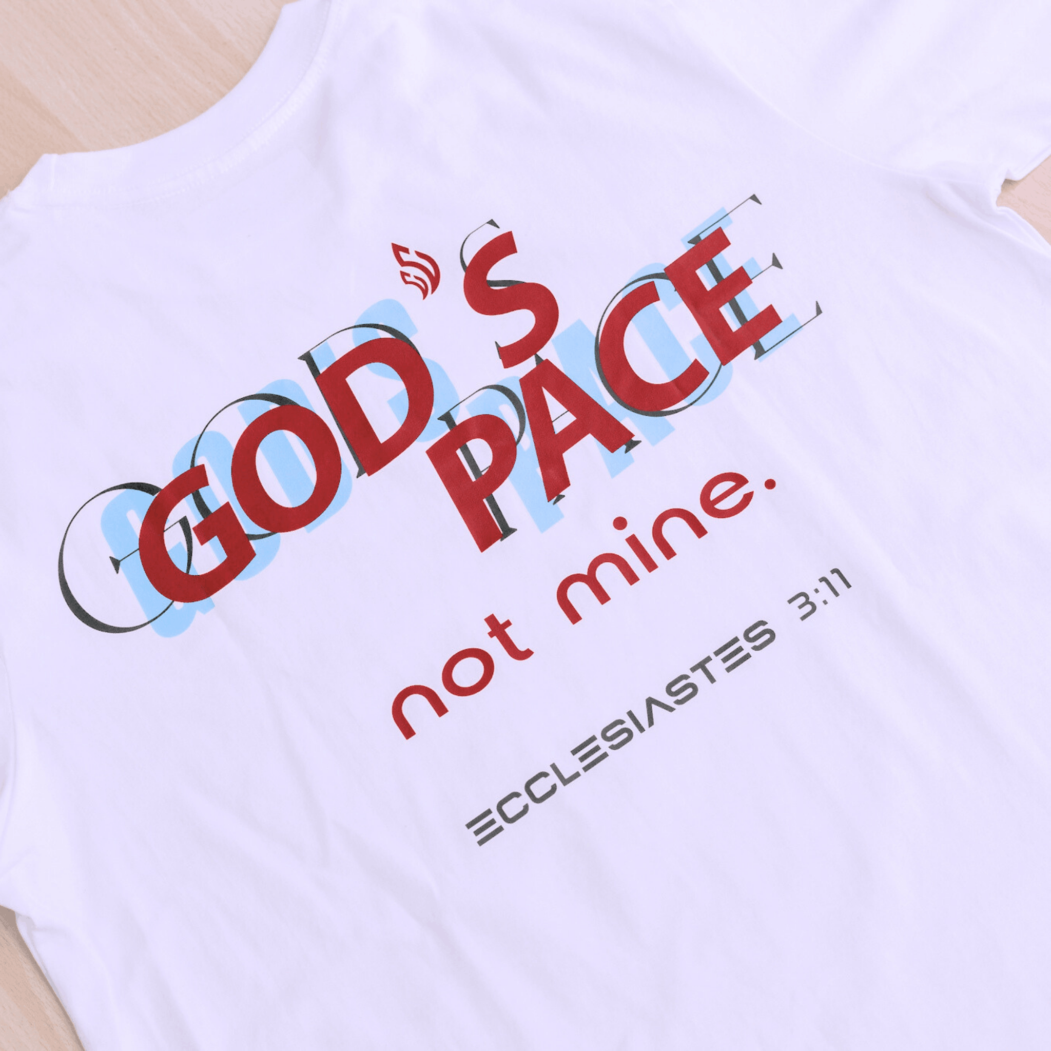 White t-shirt with text that says 'GOD'S PACE not mine.' and 'Ecclesiastes 3:11' below