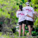Two people wearing white t-shirt with text that says 'GOD'S PACE not mine.' and 'Ecclesiastes 3:11' below, standing close together outdoors