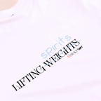 White t-shirt with a print that says 'LIFTING spirits 𝖶̶𝖤̶𝖨̶𝖦̶𝖧̶𝖳̶𝖲̶' 