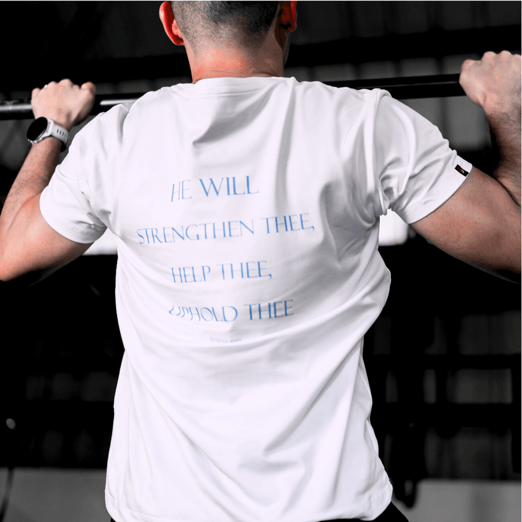 A person in the gym wearing a white t-shirt that says 'HE WILL STRENGTHEN THEE, HELP THEE, UPHOLD THEE ISAIAH 4:10' while doing pull-ups