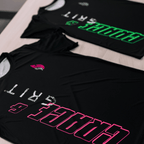 A pink and black and mint and black running shirts on a table
