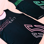 Two black running singlets with vibrant colored text and design (pink and black, mint and black) on a table