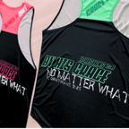 Two black running singlets with vibrant colored text and design (pink and black, mint and black) on a table