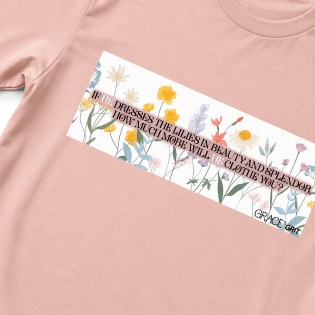 Peach t-shirt with a graphic of flowers and text on a white background