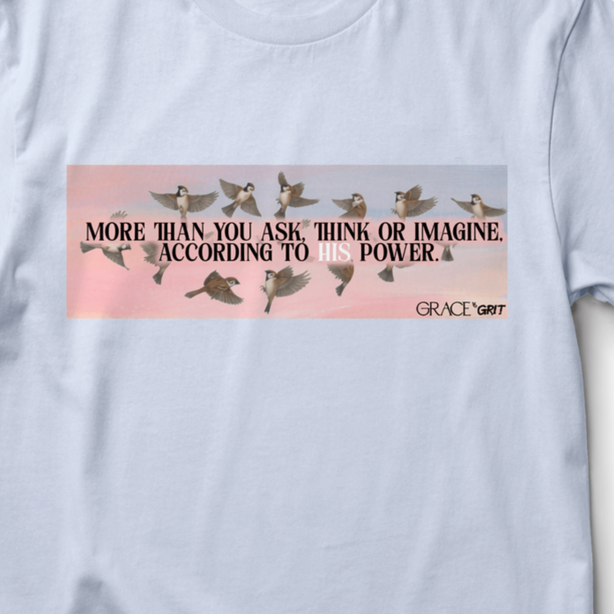 light blue t-shirt with motivational graphic and text on a light gray background